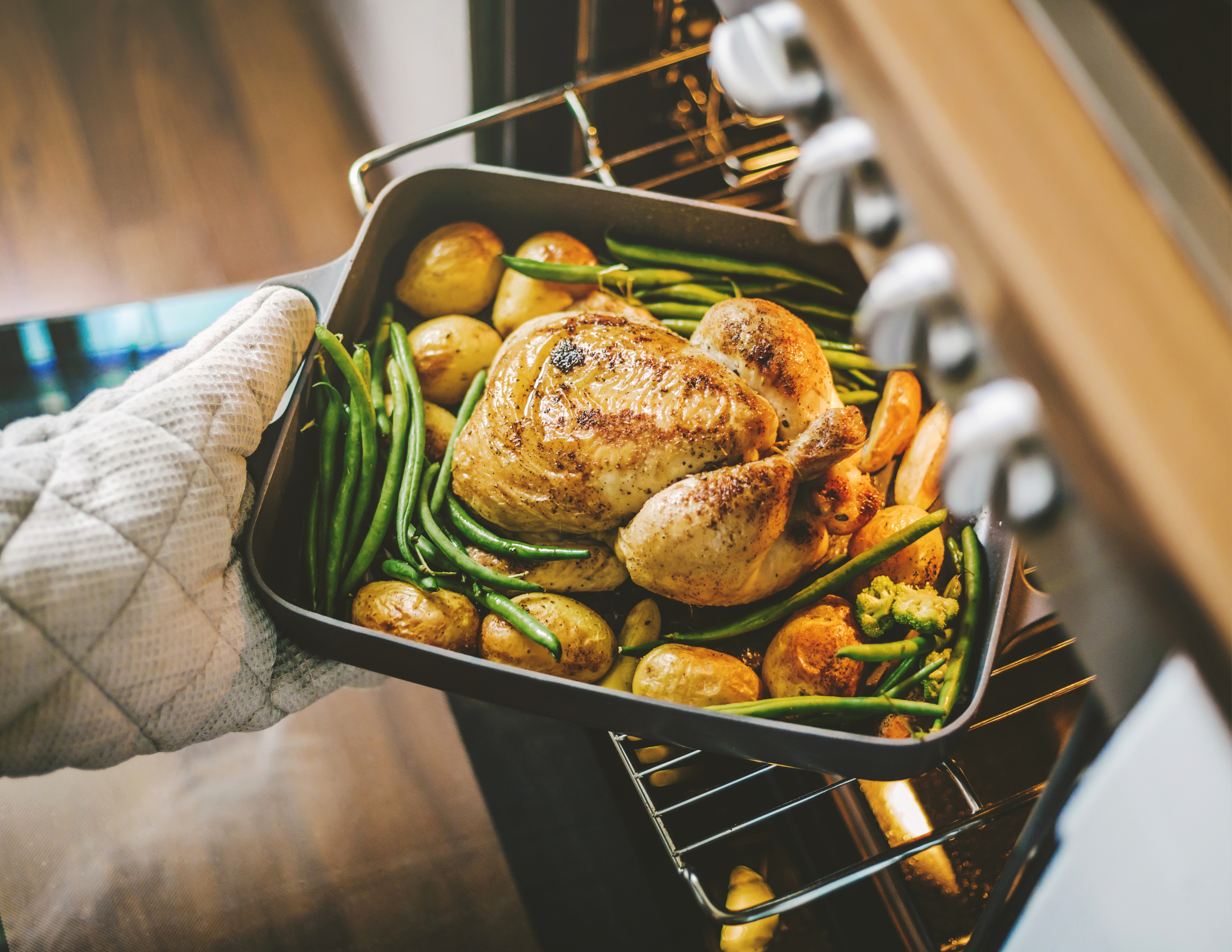 Baked chicken coming out of oven